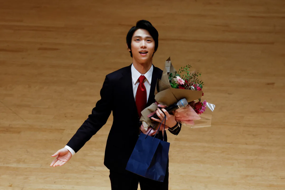 Japanese figure skater Yuzuru Hanyu holds flowers as he attends a ceremony commemorating the 50th anniversary of normalization of diplomatic relations between Japan and China in Tokyo, Japan, on Sept. 29, 2022. (Issei Kato/Reuters)