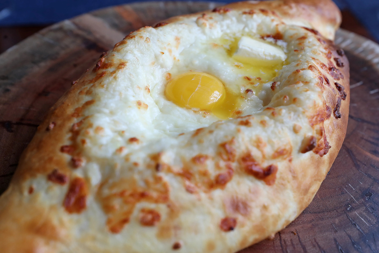 Adjarian khachapuri, a bulging flatbread shaped like a dugout canoe, is a signature dish at Askaneli, a Georgian restaurant in downtown Fort Lauderdale.