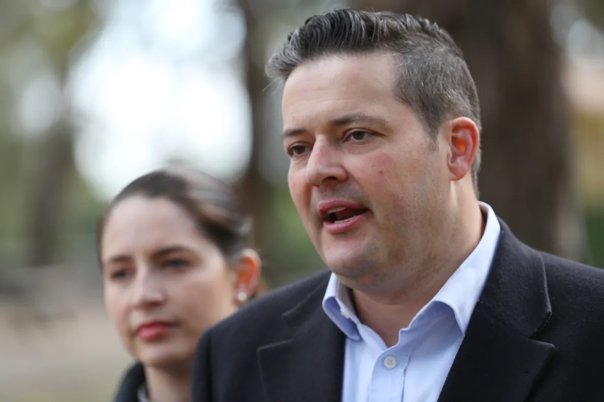 Victorian MP Will Fowles, with his wife Jessica, speaks to the media during a press conference in Melbourne, Australia, on Oct. 11, 2019. (AAP Image/David Crosling)