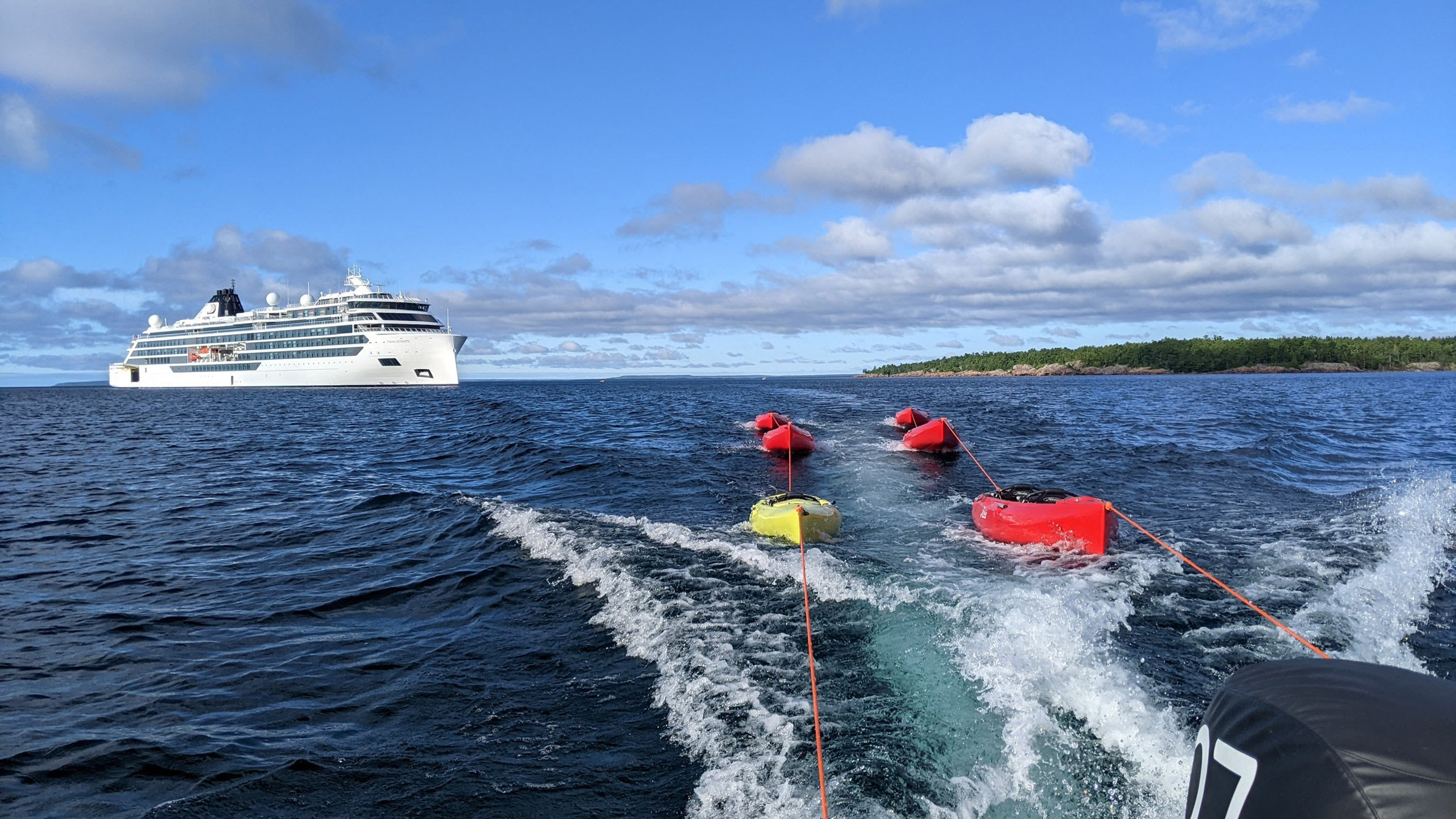 Kayaks trailed behind a Zodiac boat during an expedition from the cruise ship Viking Octantis in Lake Huron's Georgian Bay near Killarney, Ontario.