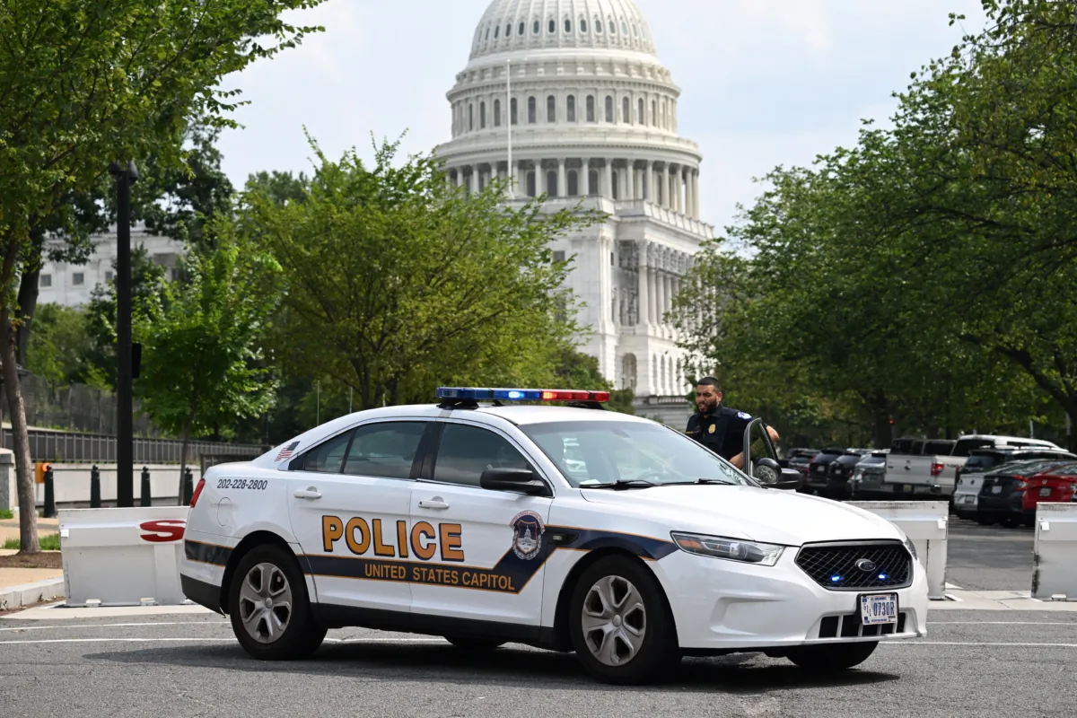 A U.S. Capitol Police officer stands by his car outside the Russell Senate Office Building in Washington after unconfirmed reports of an active shooter in the building near the U.S. Capitol on Aug. 2, 2023. (Saul Loeb/AFP via Getty Images)