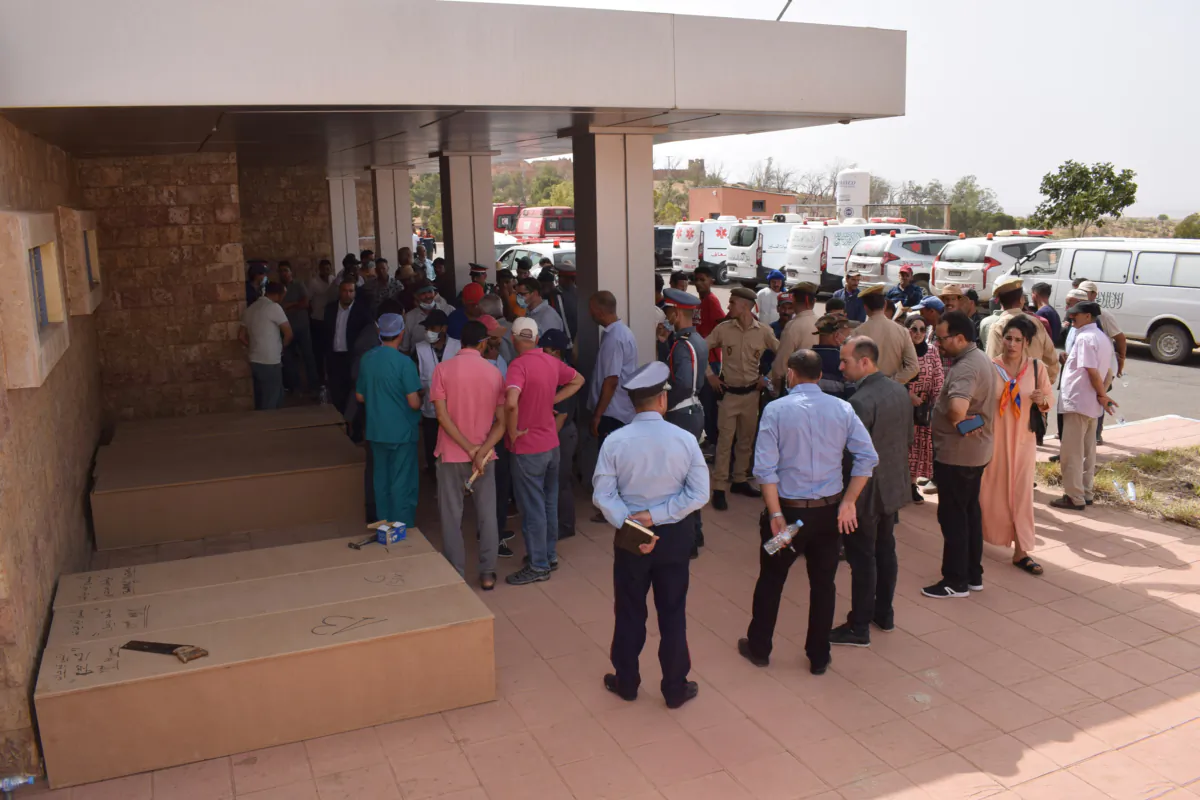 Families gather outside the morgue in the town of Demnate, in the central province of Azilal, after a minibus carrying market-goers plunged into a ravine killing 24 people, on Aug. 6, 2023. (AFP via Getty Images)