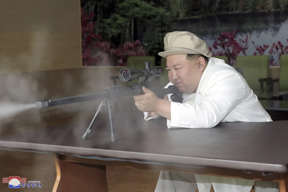In this undated photo provided by the North Korean regime, North Korean leader Kim Jong Un tries a weapon during his three-day inspection from Aug. 3 until Aug. 5, 2023 at major munitions factories in North Korea. (Korean Central News Agency/Korea News Service via AP)