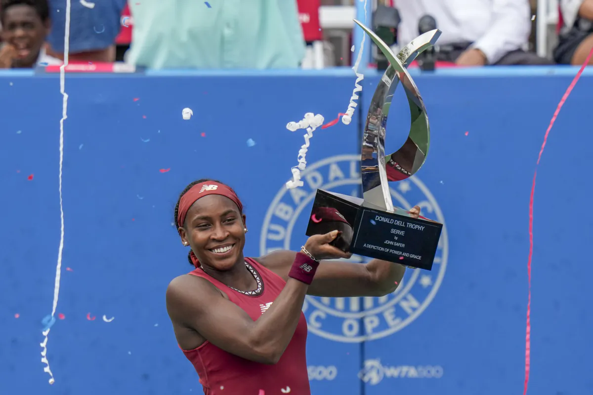 Coco Gauff, of the United States, holds the trophy as she celebrates after defeating Maria Sakkari, of Greece, in the women's singles final of the DC Open tennis tournament in Washington on Aug. 6, 2023. (Alex Brandon/AP Photo)
