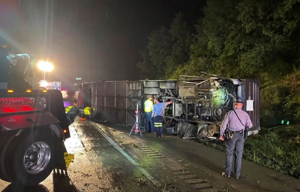 Police and rescue workers arrive on the scene of a bus crash late Sunday, in Lower Paxton Township, Dauphin County, Pa., on Aug. 6, 2023. (Pennsylvania State Police via AP)