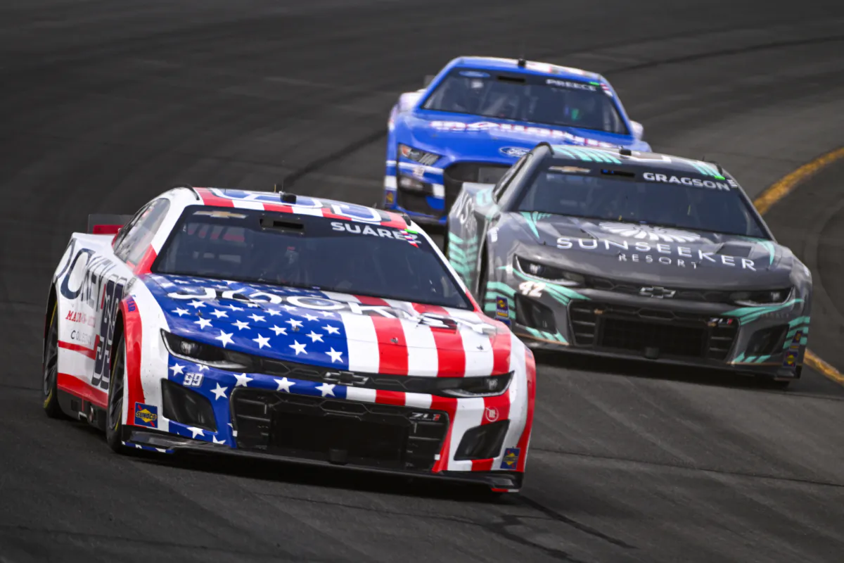 Daniel Suarez, driver of the #99 Jockey Chevrolet, Noah Gragson, driver of the #42 Sunseeker Resort Chevrolet, and Ryan Preece, driver of the #41 Mohawk Northeast Ford, race during the NASCAR Cup Series HighPoint.com 400 at Pocono Raceway on July 23, 2023 in Long Pond, Pennsylvania. (Photo by Logan Riely/Getty Images)