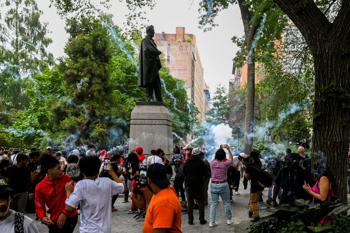 People run as a fireworks blow up as Members of the NYPD respond to the disruptions caused by large crowds during a "giveaway" event hosted by popular Twitch live streamer Kai Cenat in Union Square and the surrounding area in New York City on Aug. 4, 2023. (Alexi J. Rosenfeld/Getty Images)