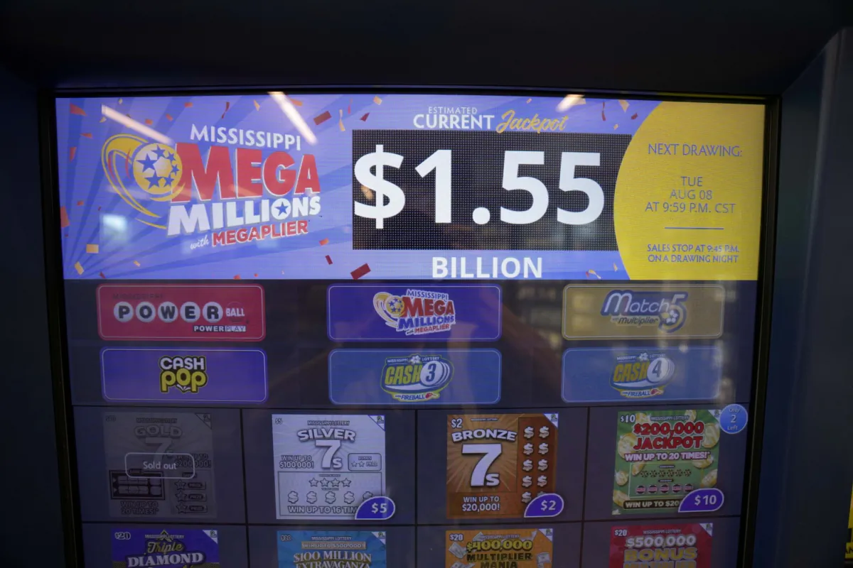 An electronic sign on a scratch off dispenser, beckons players to cast their lot at winning all or part of Tuesday's Mega Millions drawing of $1.55 billion, at this Jackson, Miss., convenience store on Aug. 7, 2023. (Rogelio V. Solis/AP Photo)