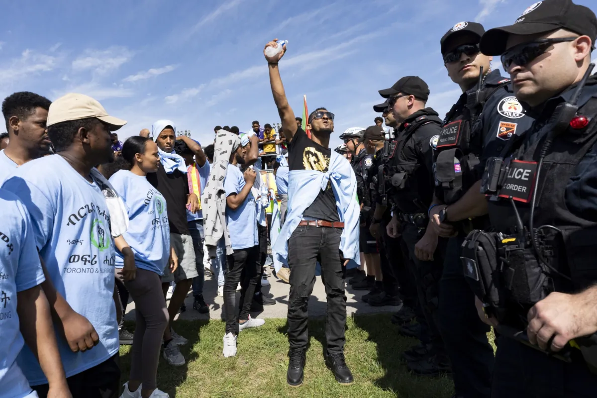 Toronto Police work the scene of a protest that turned violent in Earlscourt Park in Toronto on Aug. 5 2023. Police said one person was stabbed and eight others injured during a protest in the city’s west end. (The Canadian Press/Arlyn McAdorey)
