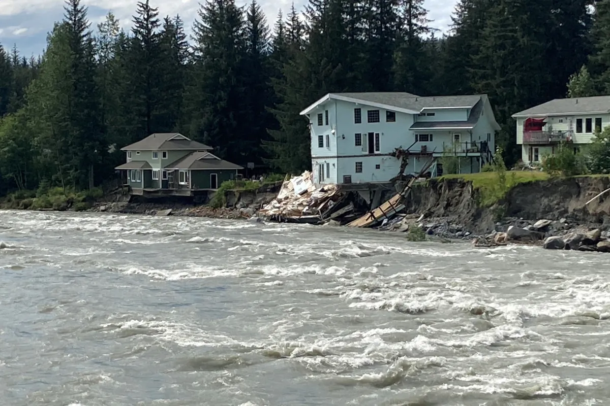 The swollen Mendenhall River courses along a neighborhood in Juneau, Alaska, on Aug. 6, 2023, after a glacial dam burst earlier in the weekend caused flooding along the river and Mendenhall Lake. (BeckyBohrer/AP Photo)