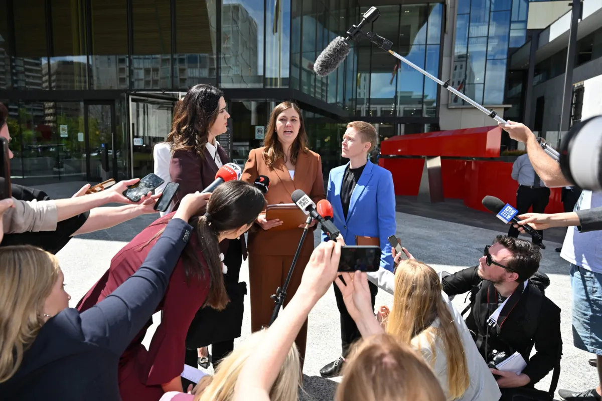 Former Liberal Party staffer Brittany Higgins (C) makes a statement while ACT Victims of Crime Commissioner Heidi Yates (R) looks on at the ACT Supreme Court in Canberra, Australia, on Oct. 27, 2022. (AAP Image/Mick Tsikas)