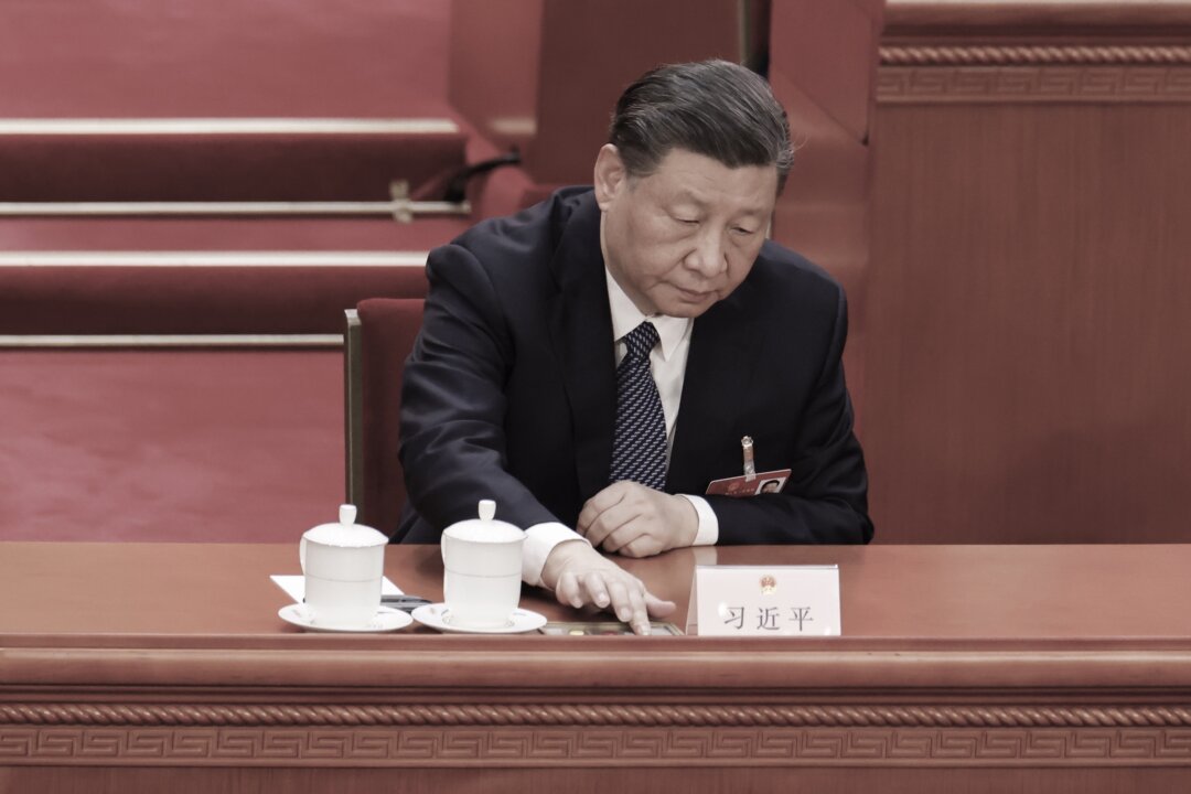 Chinese leader Xi Jinping presses a voting button during the opening of the fifth plenary session of China's rubber-stamp legislature, the National People's Congress, in Beijing on March 12, 2023. (Lintao Zhang/Getty Images)