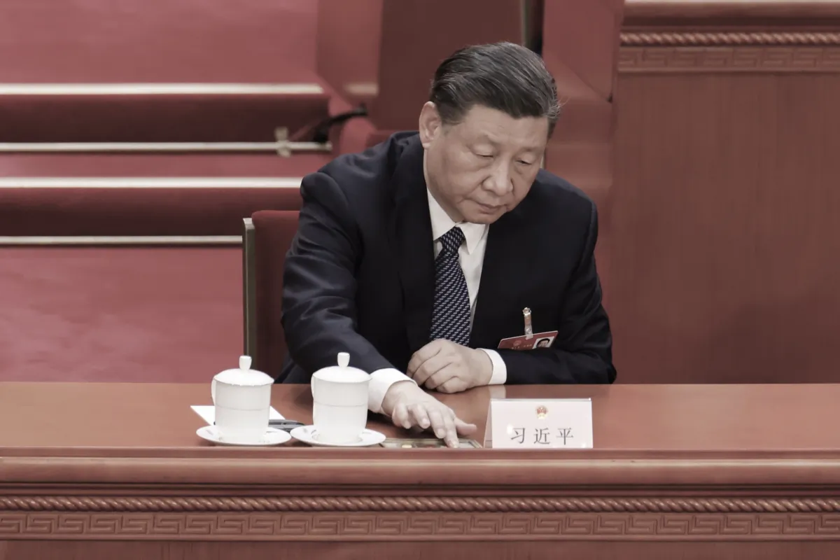 Chinese leader Xi Jinping presses a voting button during the opening of the fifth plenary session of China's rubber-stamp legislature, the National People's Congress, in Beijing on March 12, 2023. (Lintao Zhang/Getty Images)