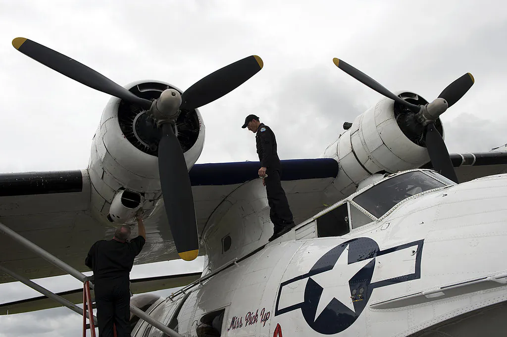 Aircrew clean a Catalina flying boat at the Farnborough International Airshow in Hampshire, southern England, on July 10, 2012. (Adrian Dennis/AFP/Getty Images)