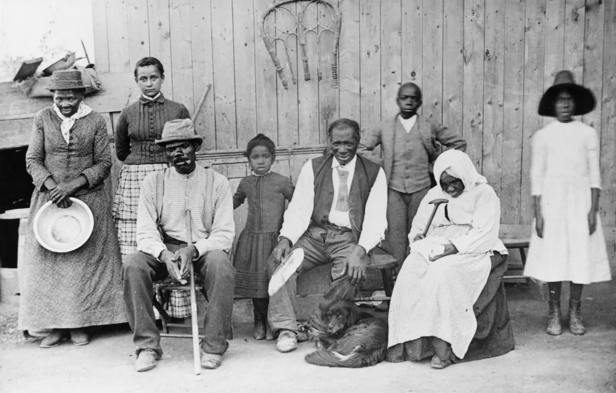 Harriet Tubman (left) poses with family and friends on her porch in Auburn, New York, in the 1880s. Ms. Tubman helped people escape slavery via the Underground Railroad, which terminated in Canada. (MPI/Getty Images)