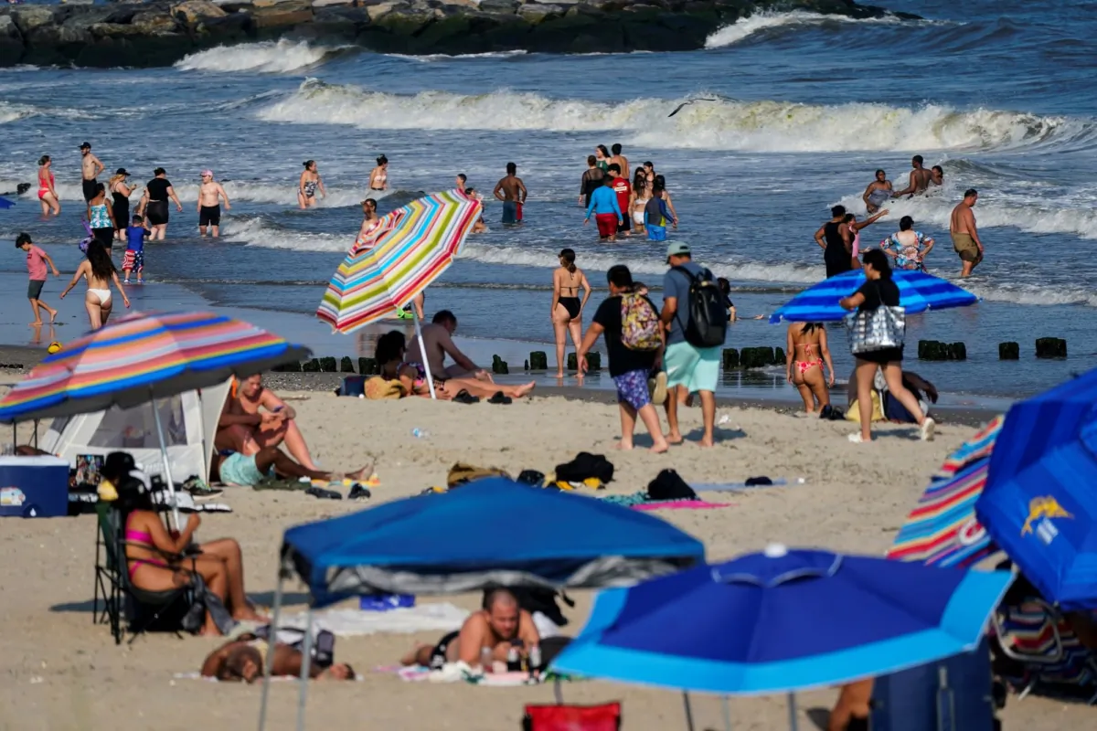 People enjoy the water at Rockaway Beach in the Queens borough of New York on July 19, 2022. (Frank Franklin II/AP)