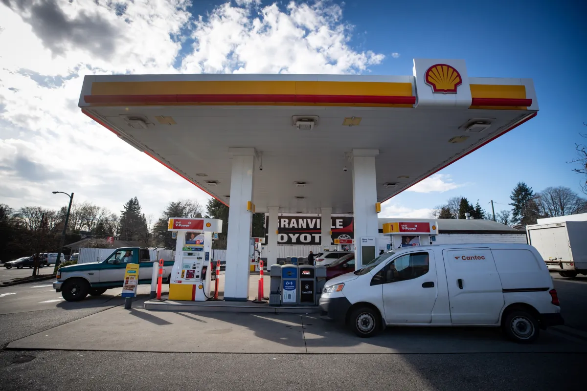 Motorists fuel up at a gas station in Vancouver on March 8, 2022. (The Canadian Press/Darryl Dyck)