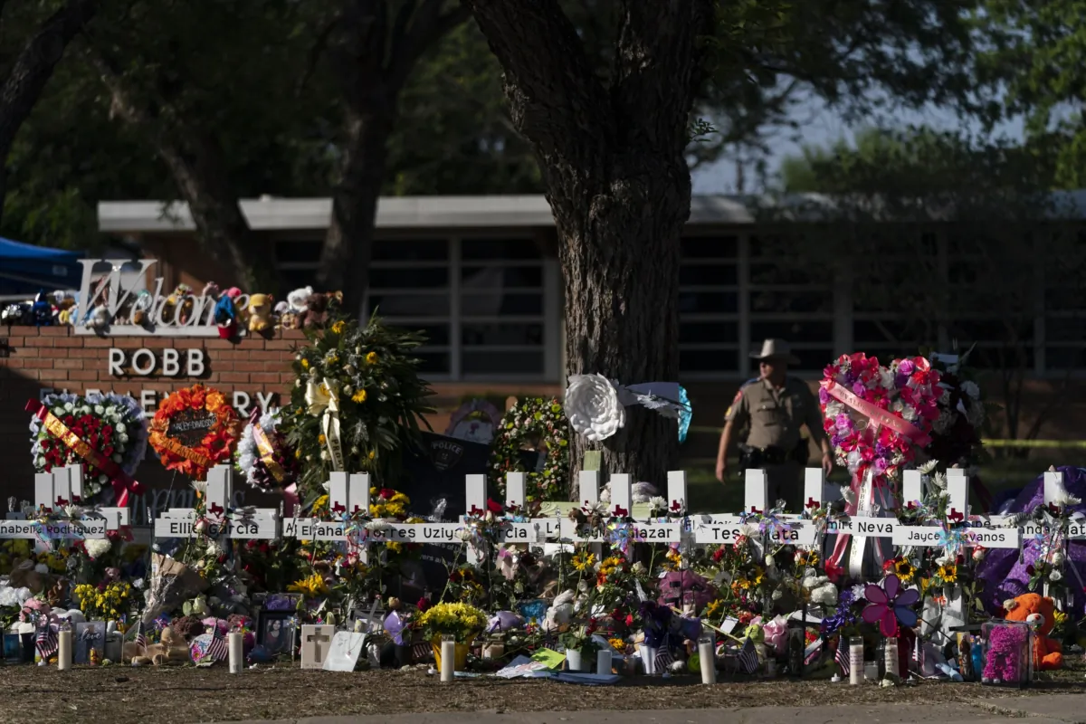 Flowers and candles are placed around crosses at a memorial outside Robb Elementary School in Uvalde, Texas, on May 28, 2022, to honor the victims killed in the school shooting. (Jae C. Hong/AP Photo)