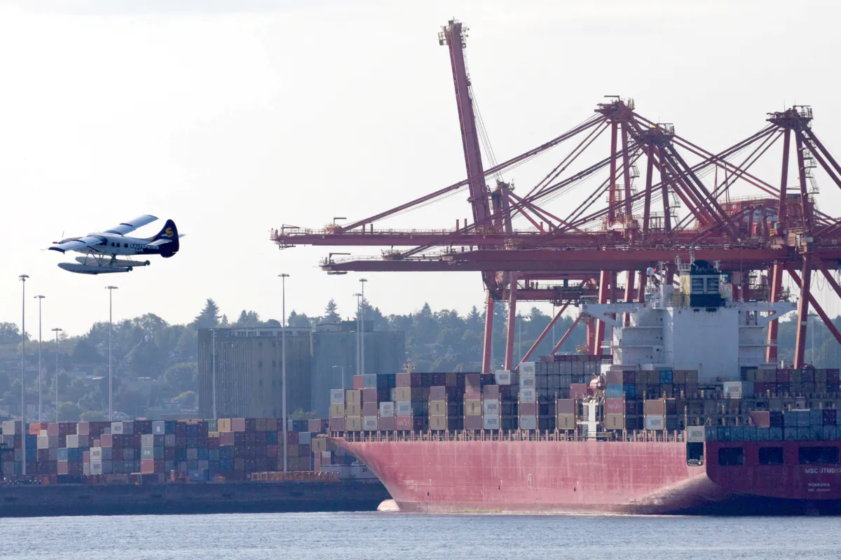A float plane flies past containers and cranes at the Port of Vancouver, British Columbia, Canada, July 30, 2023. (Reuters/Chris Helgren/File Photo)