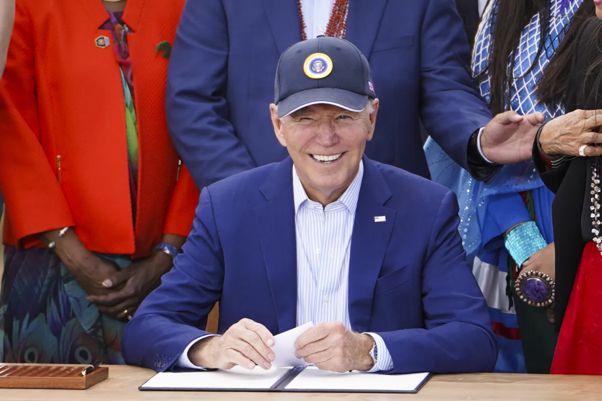 President Joe Biden (C) signs a proclamation making the Baaj Nwaavjo I'tah Kukveni Ancestral Footprints of the Grand Canyon National Monument after he spoke about investments in conservation and protecting natural resources at Red Butte Airfield, Ariz., on Aug. 8, 2023. (Madalina Vasiliu/The Epoch Times)
