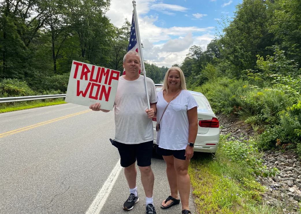 Jason Romblad and Karen Johnson, both of R.I., were among more than 2,300 people who flocked to N.H. to hear presidential candidate former President Donald Trump speak. (Alice Giordano)