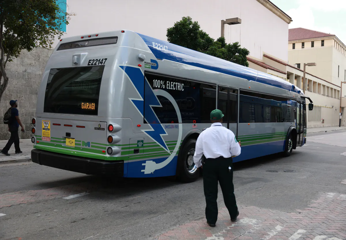 A battery-powered electric bus made by Proterra drives along a street in Miami, Fla., on Feb. 2, 2023. (Joe Raedle/Getty Images)