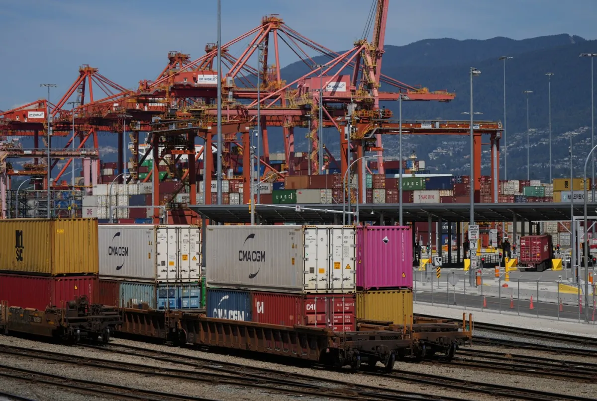 A transport truck carries a cargo container to the Centerm Container Terminal at port in Vancouver on July 14, 2023. (The Canadian Press/Darryl Dyck)