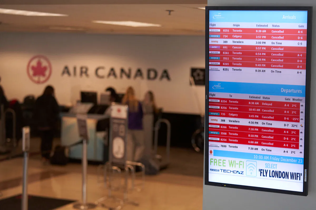 Passengers at the London International Airport try to rebook flights with Air Canada after cancellations during a large winter storm  in London, Ontario, Canada, Dec. 23, 2022. - Schools and some highways in the region were closed, and air travel was disrupted as the system made its way across the province. (Geoff Robins/AFP via Getty Images/TNS)