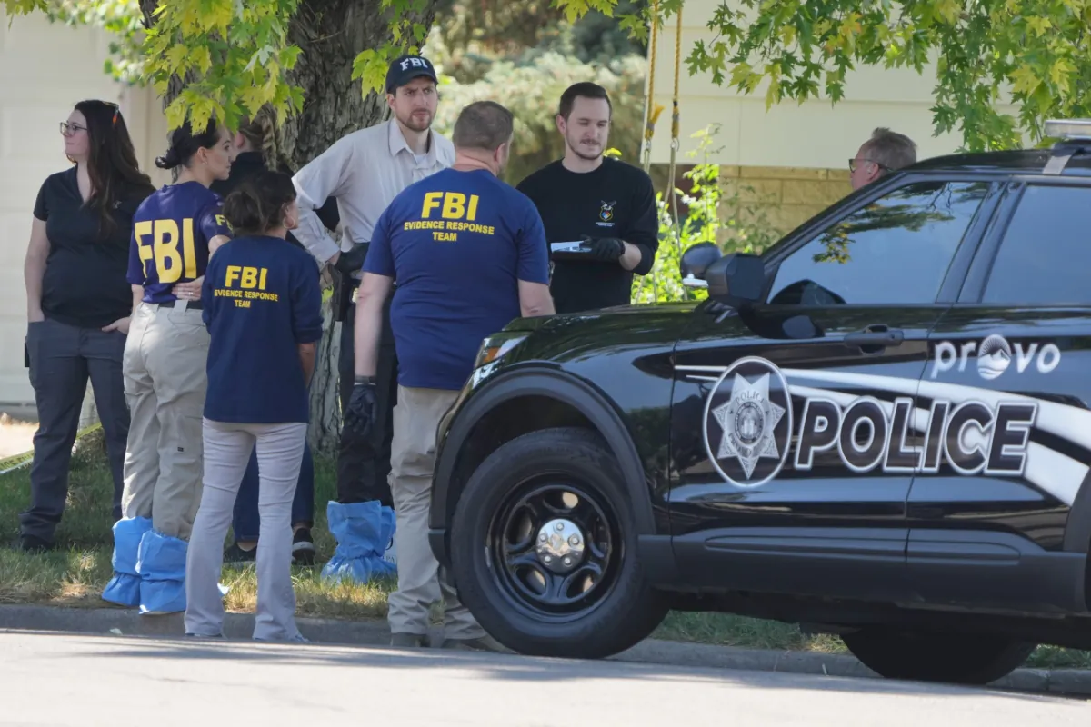 FBI agents and other law enforcement officers outside the home of Craig Robertson in Provo, Utah on Aug. 9, 2023. (George Frey/Getty Images)