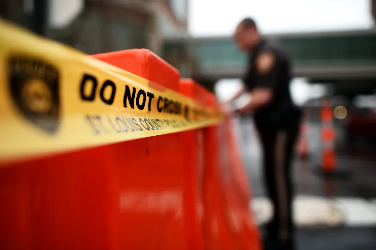 A police officer puts 'Do Not Cross' tape on barricades in a file photo. (Jewel Samad/AFP via Getty Images)