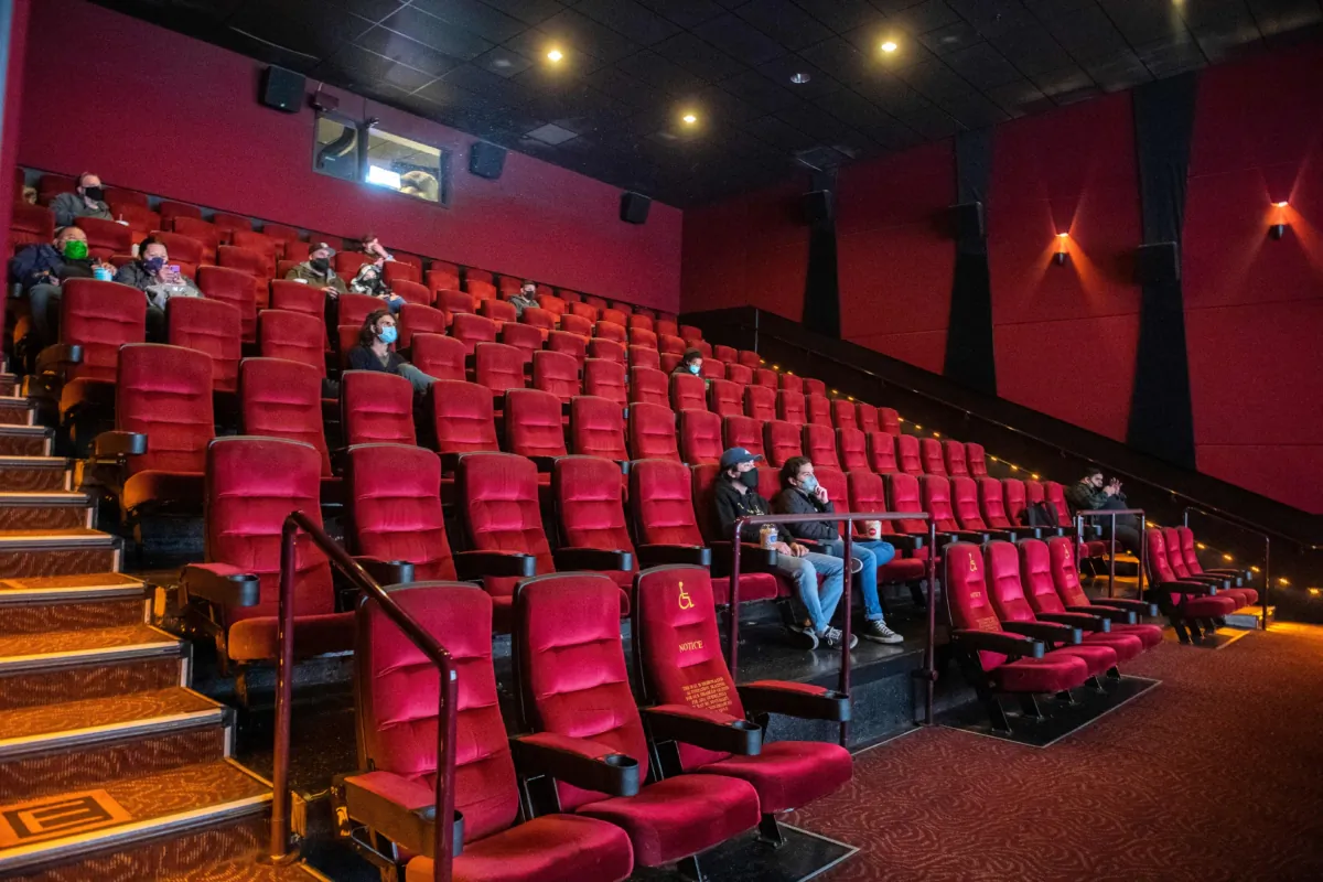 Moviegoers sit, waiting for their movie to start at the AMC Burbank theatre on reopening day in Burbank, Calif., on March 15, 2021. (Valerie Macon/AFP via Getty Images)