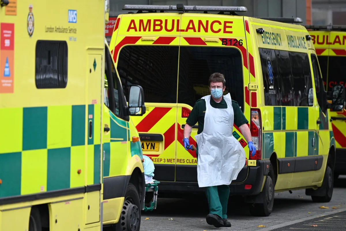 A paramedic walks past ambulances outside the Royal London Hospital in east London on Nov. 12, 2021. (Daniel Leal/AFP via Getty Images)