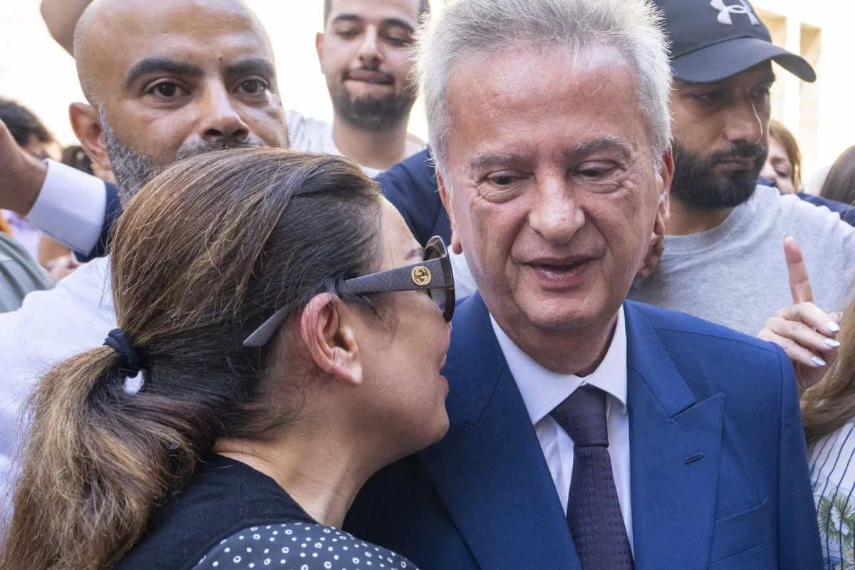 Canada is joining peers in leveraging sanctions on a trio of people tied to an alleged embezzlement scandal at Lebanon’s central bank. Riad Salameh, right, Lebanon's outgoing Central Bank governor, greets employees at a farewell ceremony marking the end of his 30 years in office outside the Central Bank building, in Beirut, July 31, 2023. (The Canadian Press/AP/Hassan Ammar)
