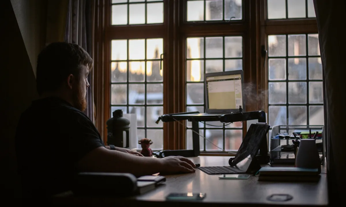 Michael Miller, 21, continues to study for his degree in biology via online learning sessions from his room in Gonville and Caius College at the University of Cambridge, England, on Jan. 29, 2021. (Leon Neal/Getty Images)