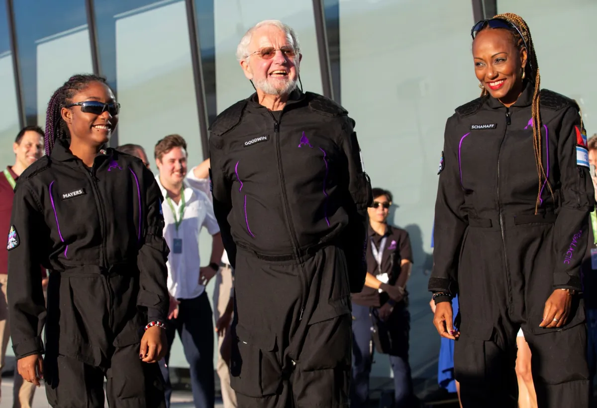 Space tourists, (L–R) Anastatia Mayers, Jon Goodwin, and Keisha Schahaff pose for photos before boarding their Virgin Galactic flight at Spaceport America, near Truth or Consequences, N.M., on Aug. 10, 2023.(Andrés Leighton/AP Photo)
