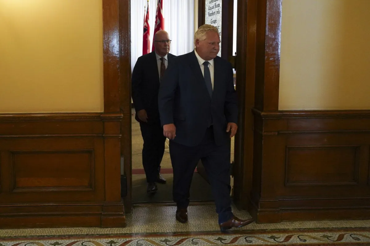 Ontario Premier Doug Ford, right, followed by Minister of Municipal Affairs and Housing Steve Clark leave a press conference following the release of the Auditor General’s Special Report on Changes to the Greenbelt, at Queens Park, in Toronto, Aug. 9, 2023. (The Canadian Press/Arlyn McAdorey)