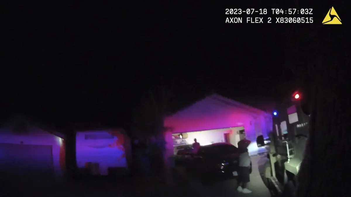 An unidentified man and woman are seen as SWAT officers raided a home in the nearby city of Henderson, Nev., on July 17, 2023, in connection with the 1997 killing of rapper Tupac Shakur near the Las Vegas Strip. (Las Vegas Metropolitan Police Department via AP)