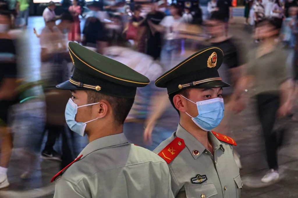 Chinese paramilitary policemen stand guard on a street in Shanghai on Oct. 5, 2021. (Hector Retamal/AFP via Getty Images)