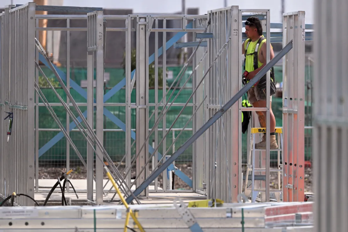 A man works on a construction site, building new apartments in Melbourne, Australia, on April 4, 2023. (William West/AFP via Getty Images)