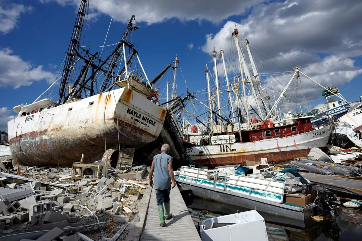 One week after the passage of Hurricane Ian, Bruce Hickey walks along the waterfront, now littered with debris including shrimp boats, on San Carlos Island, Fort Myers Beach, Fla., on Oct. 5, 2022. (Rebecca Blackwell/AP Photo)