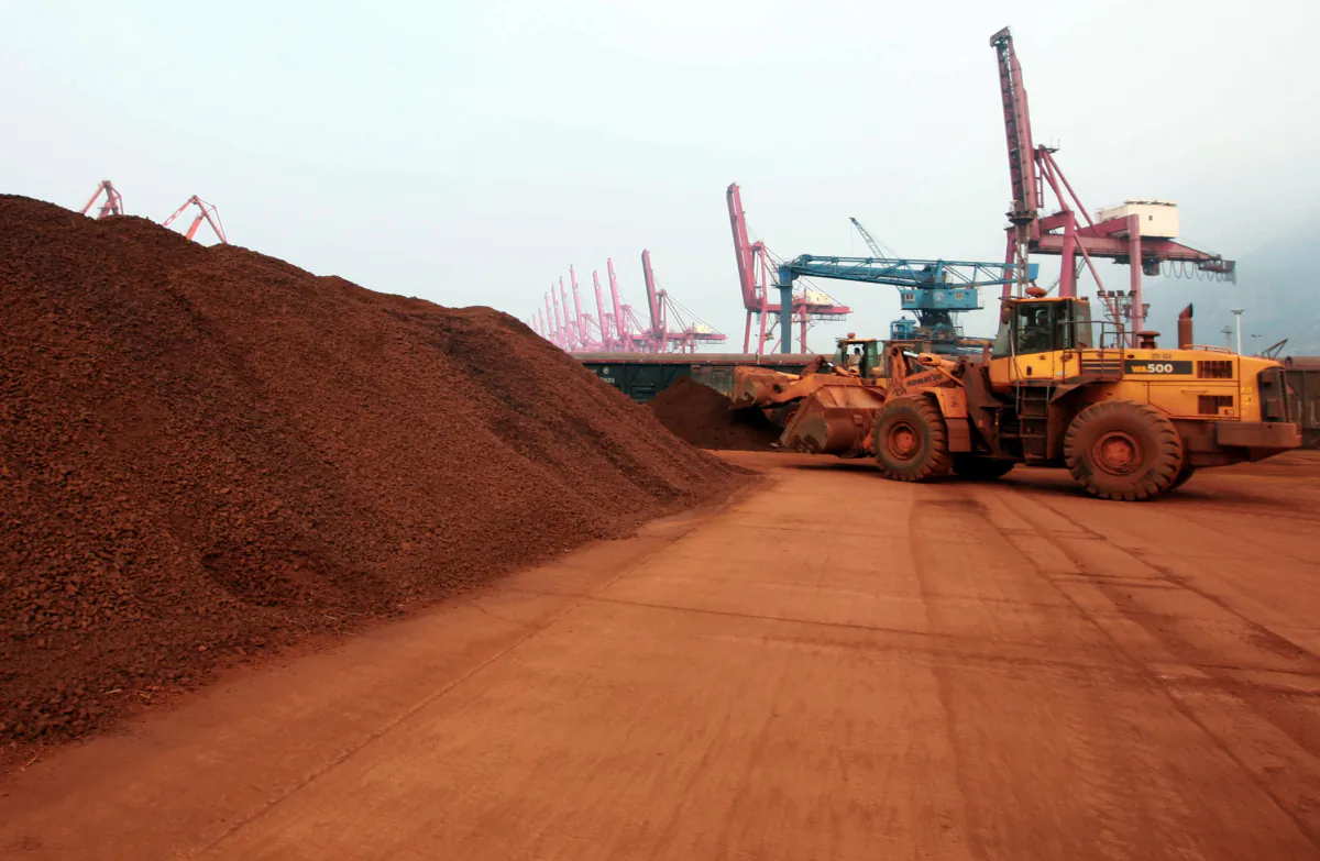 A front loader shifts soil containing rare earth minerals to be loaded at a port in Lianyungang, east of China's Jiangsu Province, on Sept. 5, 2010. (STR/AFP via Getty Images)