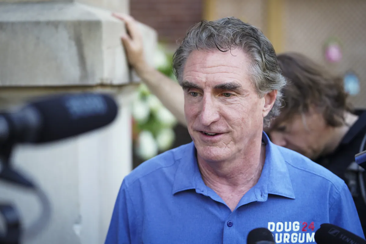 South Dakota Gov. Doug Burgum speaks with reporters at the Iowa State Fair in Des Moines, Iowa, on Aug. 11, 2023. (Madalina Vasiliu/The Epoch Times)