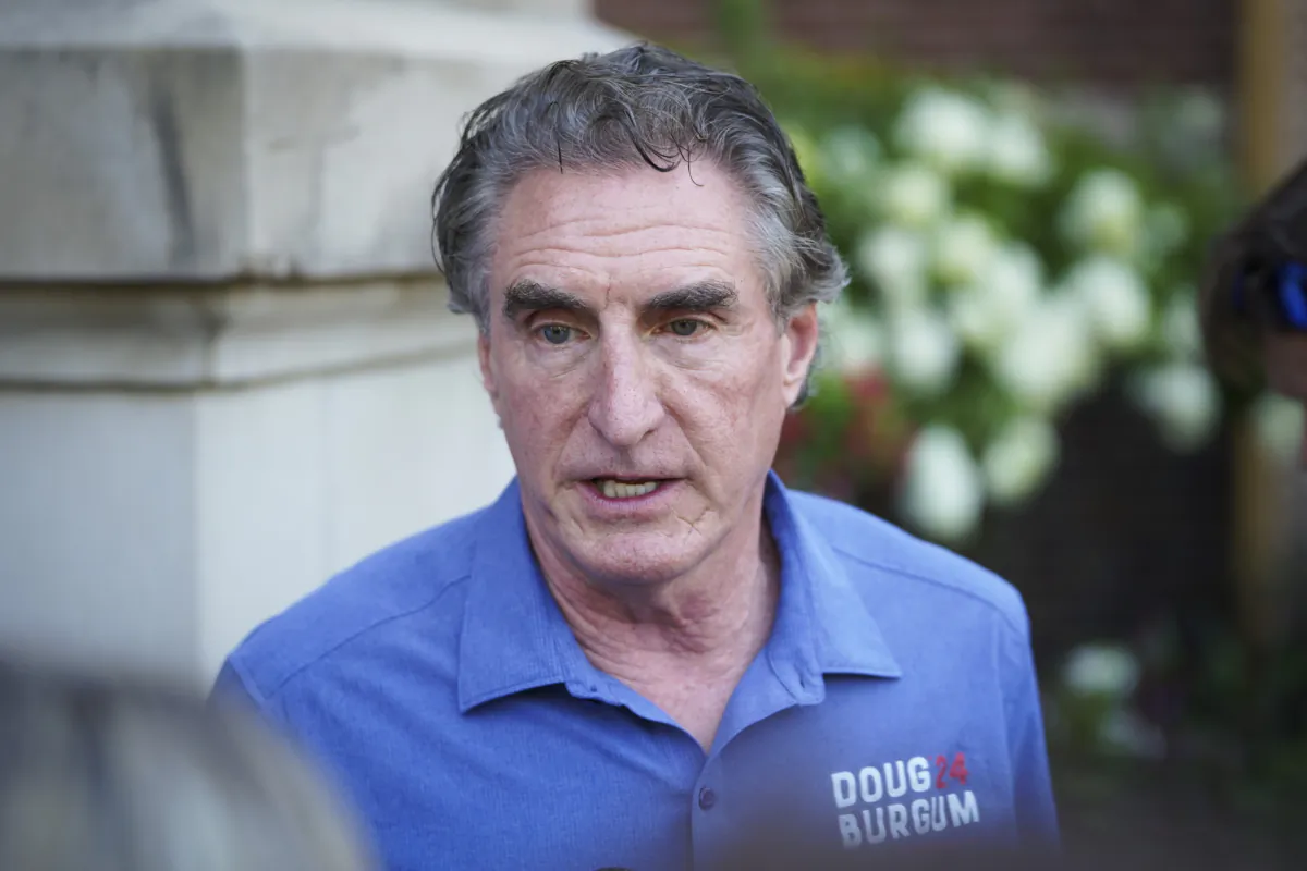 South Dakota Gov. Doug Burgum speaks with reporters at the Iowa State Fair in Des Moines, Iowa, on Aug. 11, 2023. (Madalina Vasiliu/The Epoch Times)