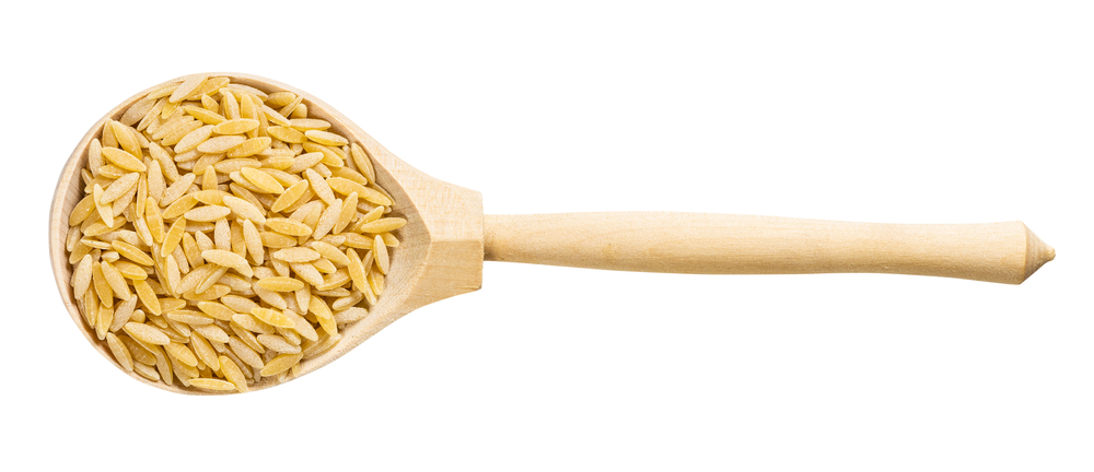 Top View Of Wood Spoon With Uncooked Orzo Risoni Pasta
