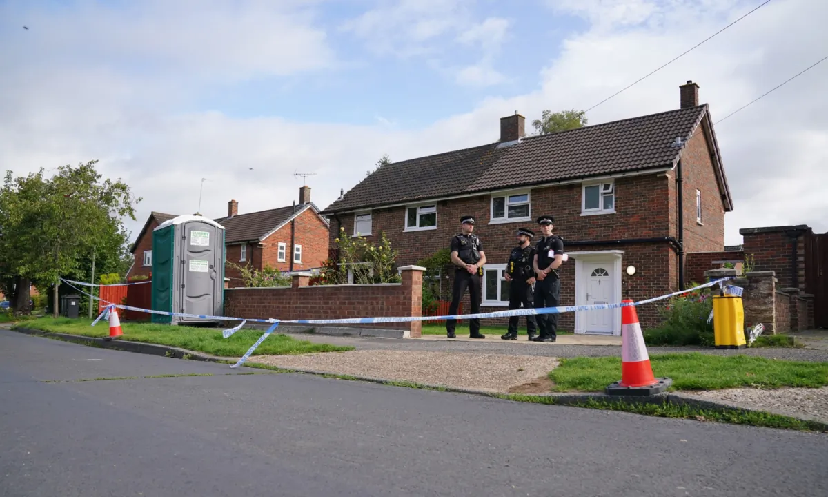 Surrey Police officers outside a property on Hammond Road in Woking, Surrey, on Aug. 11, 2023, one day after a 10-year-old girl was found dead in the property. (Jonathan Brady/PA)