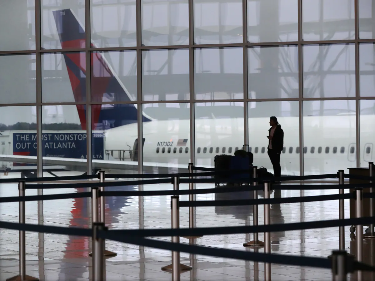 A Delta plane sits at the International Terminal at Atlanta's Hartsfield-Jackson International Airport in March 2020. (Curtis Compton/Atlanta Journal-Constitution/TNS)