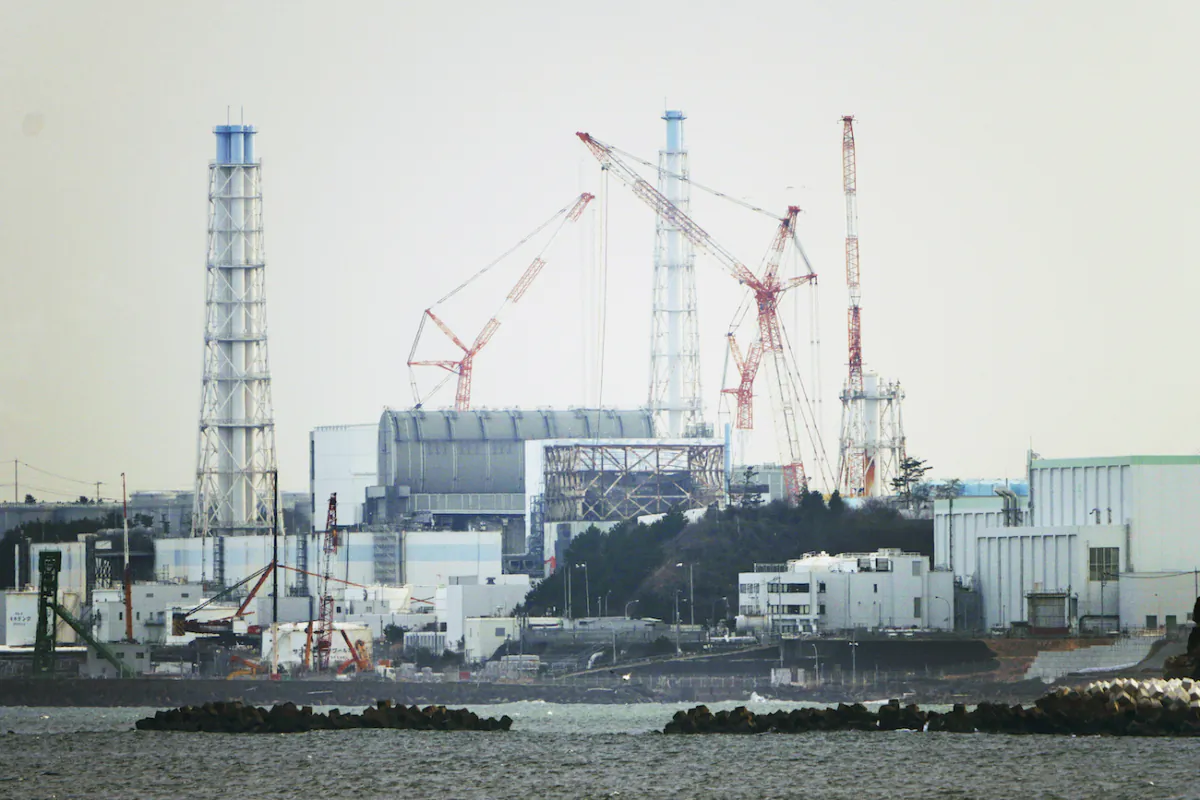 The Fukushima Daiichi nuclear power plant sits in coastal towns of both Okuma and Futaba, as seen from the Ukedo fishing port in Namie town, northeastern Japan, on March 2, 2022. (Hiro Komae/AP Photo)
