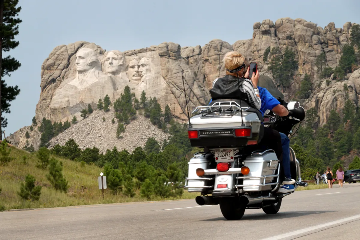 A motorcyclist rides along the road to Mt. Rushmore near Keystone, S.D., on Aug. 9, 2021. (Scott Olson/Getty Images)