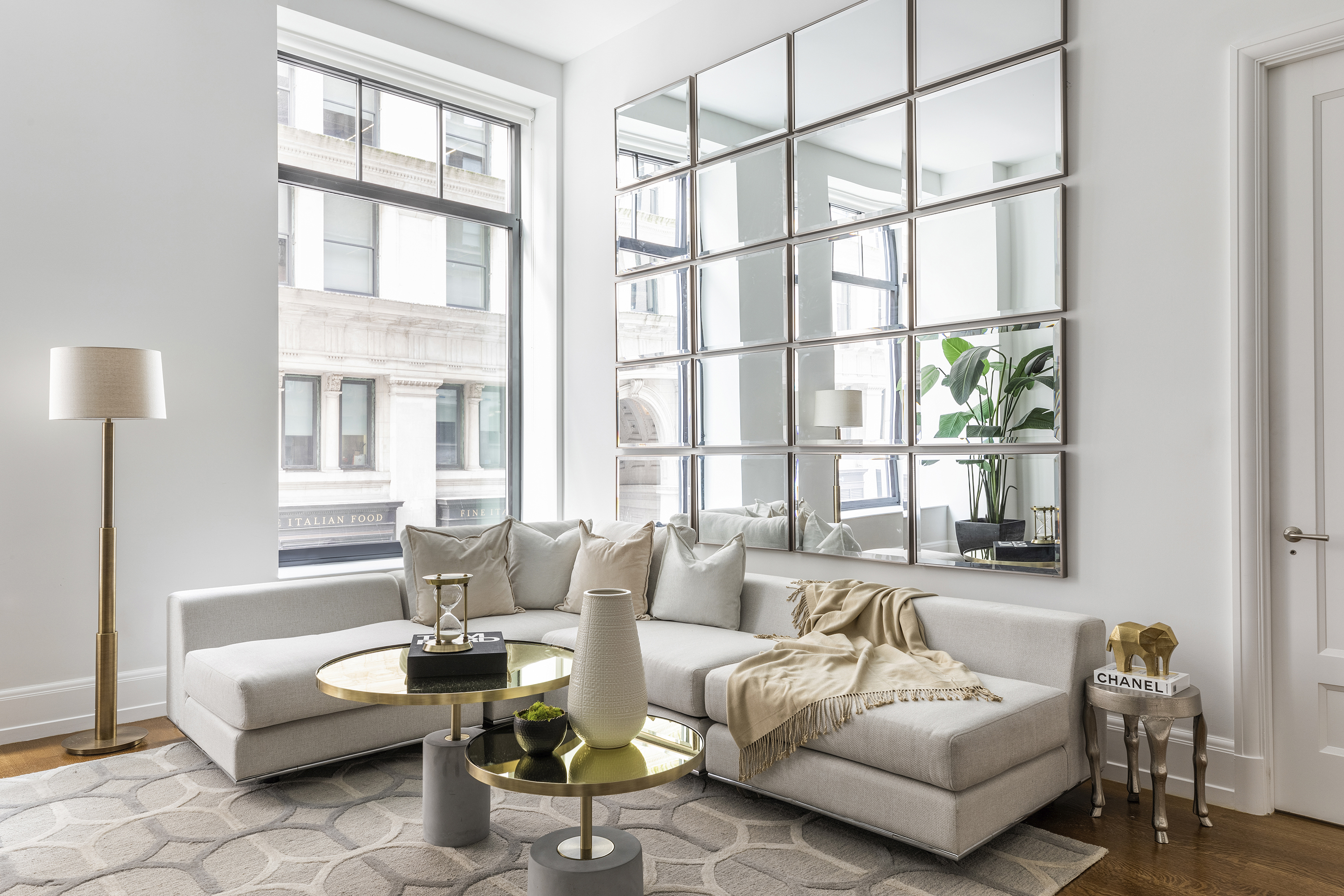Soft neutral toss pillows and throws are paired with a cream sofa for a soft, warm vibe.