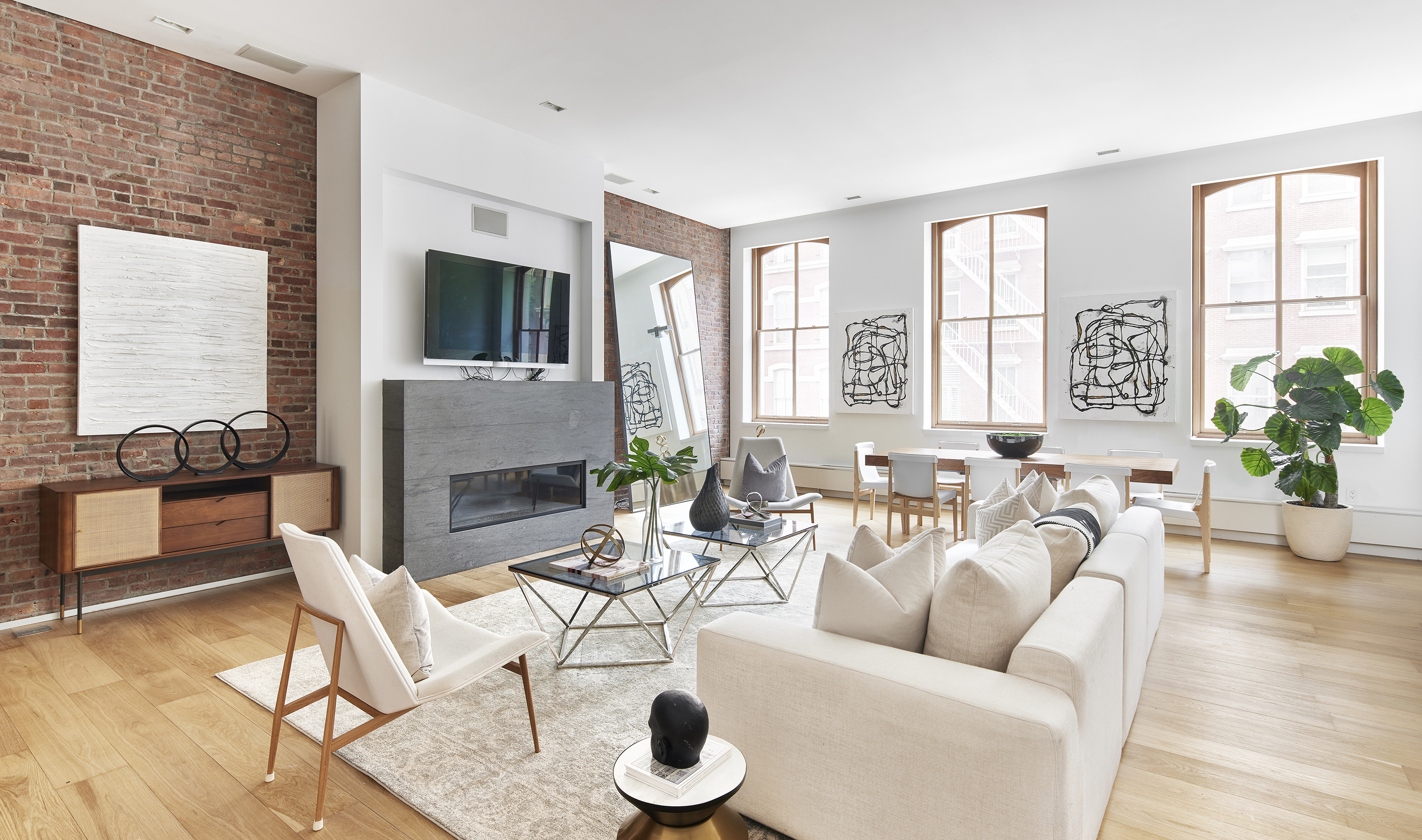 White upholstered pieces are paired with wood elements to create a midcentury vibe.